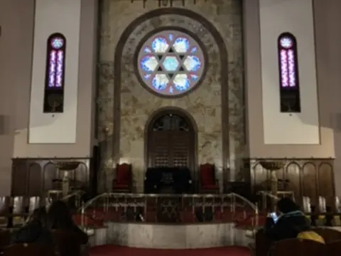 Interior of a Jewish synagogue in Galata with Star of David stained glass